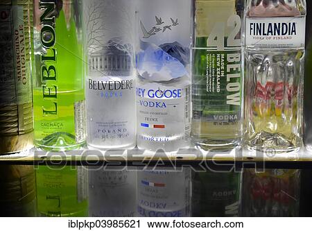 "Bottles of various spirits in a row, reflected on a glass plate" View Large Photo Image Stock Image - "Bottles of various spirits in a row, reflected on a glass plate". Fotosearch