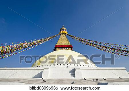 Stock Photography - "Boudnath Stupa with prayer flags against blue sky, Kathmandu Valley, Kathmandu, Kathmandu District, Bagmati Zone, Nepal, Asia". Fotosearch