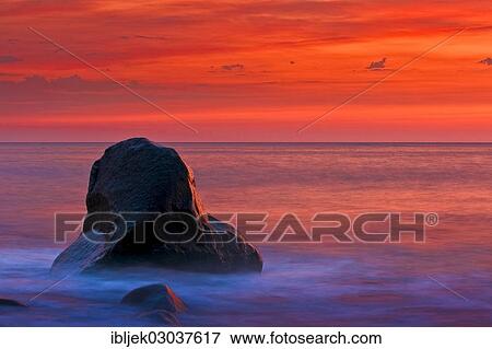 Stock Photo - "Boulder in the Baltic Sea at sunset, Jasmund National Park, Rugen island, Rugen, Mecklenburg-Western Pomerania, Germany, Europe". Fotosearch