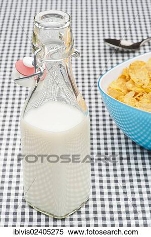 Bowl filled with corn flakes and a milk bottle View Large Photo Image Stock Photography - Bowl filled with corn flakes and a milk bottle. Fotosearch