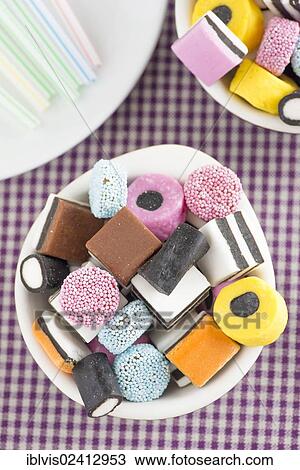 Bowls filled with liquorice candy and drinking straws View Large Photo Image Stock Image - Bowls filled with liquorice candy and drinking straws. Fotosearch