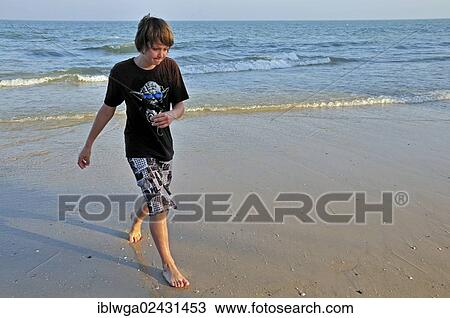 Stock Image - "Boy, 11 years, on the beach of Hua Hin, Thailand, Asia, PublicGround, Asia". Fotosearch