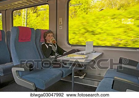 "Boy, 11 years, watching a movie on his netbook whilst travelling on an Intercity train, IC, Deutsche Bahn, German railway company, Germany, Europe" View Large Photo Image Stock Image - "Boy, 11 years, watching a movie on his netbook whilst travelling on an Intercity train, IC, Deutsche Bahn, German railway company, Germany, Europe". Fotosearch