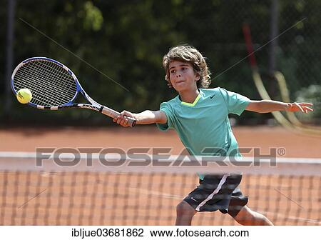 "Boy, 12, playing tennis, hitting a forehand, Munich, Upper Bavaria, Bavaria, Germany, Europe" View Large Photo Image Stock Image - "Boy, 12, playing tennis, hitting a forehand, Munich, Upper Bavaria, Bavaria, Germany, Europe". Fotosearch