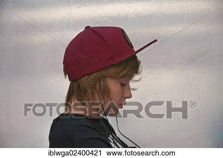 Stock Image - "Boy, 12 years, listening to music on headphones, absent minded, Germany, Europe". Fotosearch