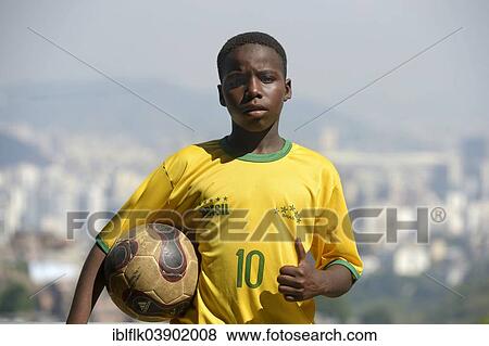 "Boy, 13 years, wearing the jersey of the Brazilian national team, holding a football, Rio de Janeiro, Brazil, South America" View Large Photo Image Stock Photo - "Boy, 13 years, wearing the jersey of the Brazilian national team, holding a football, Rio de Janeiro, Brazil, South America". Fotosearch