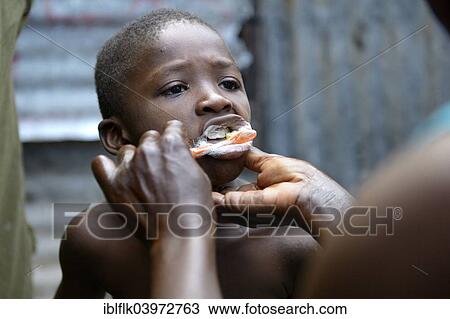 "Boy, 7 years, having his teeth brushed, Camp Icare, camp for earthquake refugees, Fort National, Port-au-Prince, Haiti, North America" View Large Photo Image Stock Image - "Boy, 7 years, having his teeth brushed, Camp Icare, camp for earthquake refugees, Fort National, Port-au-Prince, Haiti, North America". Fotosearch