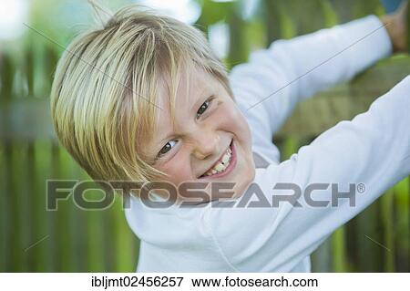 "Boy, 7 years old, hanging on to a wooden fence" View Large Photo Image Stock Photo - "Boy, 7 years old, hanging on to a wooden fence". Fotosearch