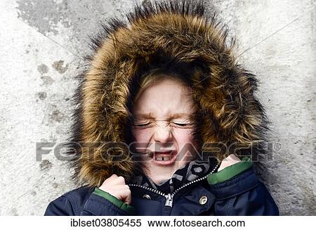 Stock Photography - "Boy, 7 years, with a fur hood, angry, portrait". Fotosearch