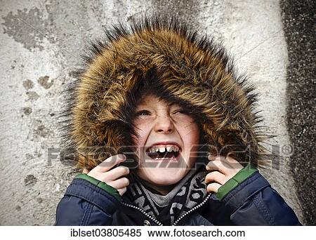 Stock Photography - "Boy, 7 years, with a fur hood, laughing, portrait". Fotosearch