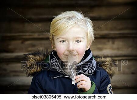 Stock Photography - "Boy, 7 years, with feather". Fotosearch