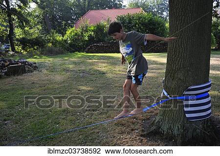 "Boy, 9 years, balancing on a slackline, Vogelsen, Lower Saxony, Germany, Europe" View Large Photo Image Stock Image - "Boy, 9 years, balancing on a slackline, Vogelsen, Lower Saxony, Germany, Europe". Fotosearch
