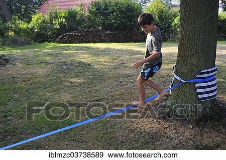 "Boy, 9 years, balancing on a slackline, Vogelsen, Lower Saxony, Germany, Europe" View Large Photo Image Stock Photo - "Boy, 9 years, balancing on a slackline, Vogelsen, Lower Saxony, Germany, Europe". Fotosearch