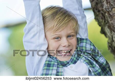 "Boy, 9 years old, climbing on a tree" View Large Photo Image Stock Image - "Boy, 9 years old, climbing on a tree". Fotosearch