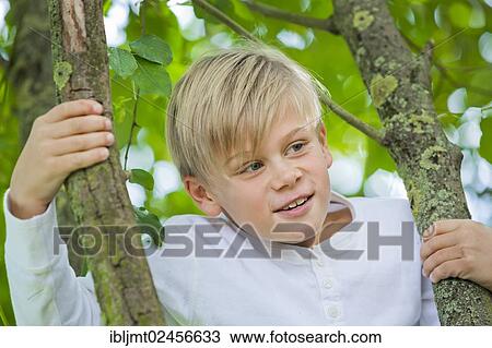 "Boy, 9 years old, climbing on a tree" View Large Photo Image Stock Image - "Boy, 9 years old, climbing on a tree". Fotosearch