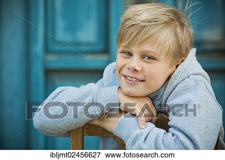 "Boy, 9 years old, sitting in front of a blue door" View Large Photo Image Stock Photo - "Boy, 9 years old, sitting in front of a blue door". Fotosearch