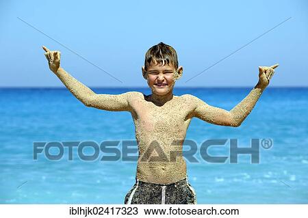 Boy, 9 years, standing on the beach with a sand-covered torso and raising his arms, Kathisma, Lefkas or Lefkada, Greece, Europe View Large Photo Image Stock Image - Boy, 9 years, standing on the beach with a sand-covered torso and raising his arms, Kathisma, Lefkas or Lefkada, Greece, Europe. Fotosearch