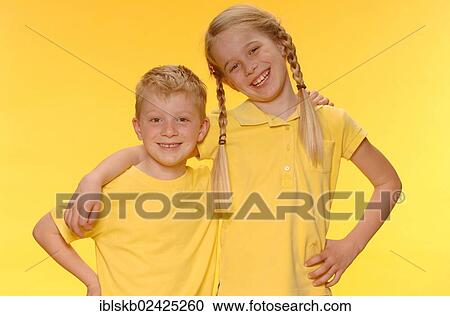 "Boy and girl, brother and sister, standing arm in arm, smiling" View Large Photo Image Stock Image - "Boy and girl, brother and sister, standing arm in arm, smiling". Fotosearch