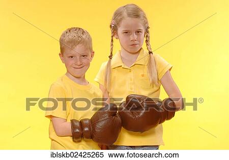 Stock Photography - "Boy and girl, brother and sister, wearing boxing gloves". Fotosearch
