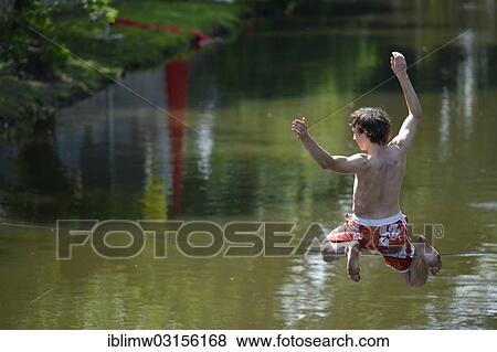 "Boy balancing on a slackline, trend sport, over the Neckar river, Heilbronn, Baden-Wurttemberg, Germany, Europe" View Large Photo Image Stock Photo - "Boy balancing on a slackline, trend sport, over the Neckar river, Heilbronn, Baden-Wurttemberg, Germany, Europe". Fotosearch
