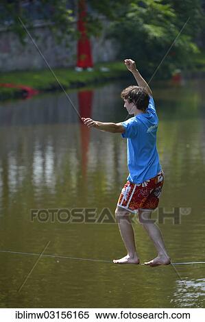 "Boy balancing on a slackline, trend sport, over the Neckar river, Heilbronn, Baden-Wurttemberg, Germany, Europe" View Large Photo Image Stock Photography - "Boy balancing on a slackline, trend sport, over the Neckar river, Heilbronn, Baden-Wurttemberg, Germany, Europe". Fotosearch