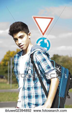 Boy carrying a school bag on the way to school View Large Photo Image Stock Image - Boy carrying a school bag on the way to school. Fotosearch