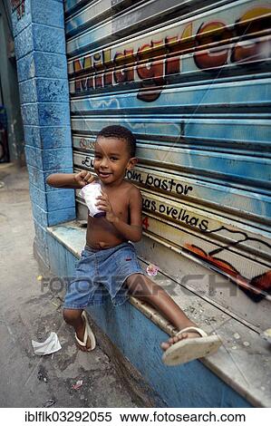 "Boy eating from a tub of ice cream in a slum or favela, Jacarezinho favela, Rio de Janeiro, Rio de Janeiro State, Brazil, South America" View Large Photo Image Stock Photography - "Boy eating from a tub of ice cream in a slum or favela, Jacarezinho favela, Rio de Janeiro, Rio de Janeiro State, Brazil, South America". Fotosearch