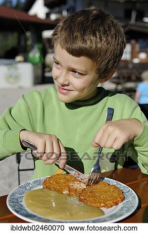 "Boy eating hash browns, Schliersbergalm alp, near lake Schliersee, Upper Bavaria, Bavaria, Germany, Europe" View Large Photo Image Stock Image - "Boy eating hash browns, Schliersbergalm alp, near lake Schliersee, Upper Bavaria, Bavaria, Germany, Europe". Fotosearch