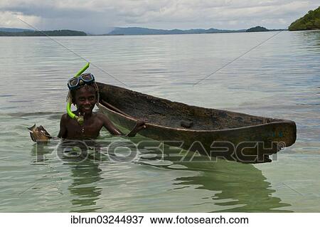 "Boy fishing with his canoe and harpoon, Marovo Lagoon, Western Province, Solomon Islands, Oceania" View Large Photo Image Stock Photo - "Boy fishing with his canoe and harpoon, Marovo Lagoon, Western Province, Solomon Islands, Oceania". Fotosearch