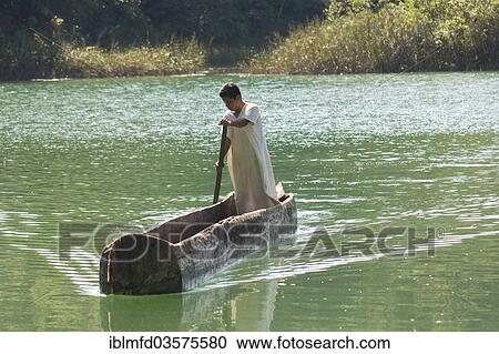 Stock Image - "Boy from the Lacandon tribe preparing to fish in the lagoon near the village of Naha, Selva Lacandona, Naha, Chiapas, Mexico, North America". Fotosearch