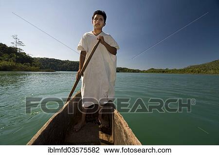 Stock Image - "Boy from the Lacandon tribe preparing to fish in the lagoon near the village of Naha, Selva Lacandona, Naha, Chiapas, Mexico, North America". Fotosearch