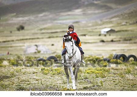 Stock Photo - "Boy from the Puruha people riding on a horse, Kichwa, Chimborazo Province, Ecuador, South America". Fotosearch