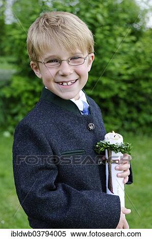 Stock Photography - "Boy holding a First Communion candle, Bavaria, Germany, Europe". Fotosearch