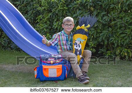 "Boy holding a """"Schultuete"""", a paper cone with treats for the first day of school, Hesse, Germany, Europe" View Large Photo Image Stock Photo - "Boy holding a """"Schultuete"""", a paper cone with treats for the first day of school, Hesse, Germany, Europe". Fotosearch