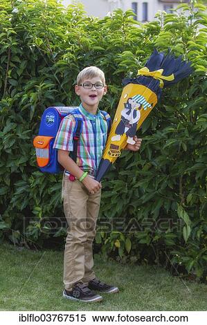 "Boy holding a """"Schultuete"""", a paper cone with treats for the first day of school, Hesse, Germany, Europe" View Large Photo Image Stock Photography - "Boy holding a """"Schultuete"""", a paper cone with treats for the first day of school, Hesse, Germany, Europe". Fotosearch