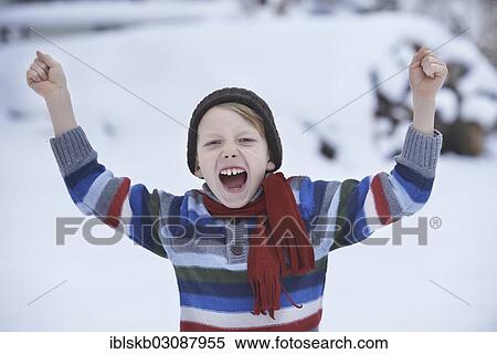 "Boy in a winter sweater and a scarf, shouting with fists raised" View Large Photo Image Stock Photography - "Boy in a winter sweater and a scarf, shouting with fists raised". Fotosearch