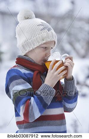 Boy in winter clothes drinking tea View Large Photo Image Stock Image - Boy in winter clothes drinking tea. Fotosearch