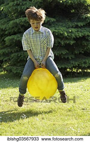 "Boy jumping with a hop ball, Germany, Europe" View Large Photo Image Stock Image - "Boy jumping with a hop ball, Germany, Europe". Fotosearch