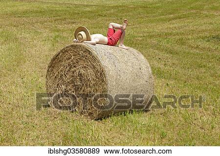 "Boy lying on a bale of straw, Germany, Europe" View Large Photo Image Stock Photo - "Boy lying on a bale of straw, Germany, Europe". Fotosearch