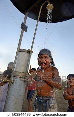 "Boy of the Xavantes people taking a shower at a waterhole, installed by missionaries, village of Urere near Sangradouro, Primavera do Leste, Mato Grosso, Brazil, South America" View Large Photo Image Stock Photograph - "Boy of the Xavantes people taking a shower at a waterhole, installed by missionaries, village of Urere near Sangradouro, Primavera do Leste, Mato Grosso, Brazil, South America". Fotosearch
