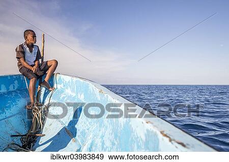 "Boy on a fishing boat looking out to the sea, Yasawa Islands, Fischi" View Large Photo Image Stock Photo - "Boy on a fishing boat looking out to the sea, Yasawa Islands, Fischi". Fotosearch
