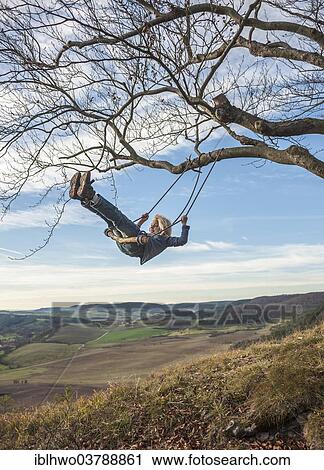 Stock Image - "Boy on an improvised swing, Eichenberg, Thuringia, Germany, Europe". Fotosearch