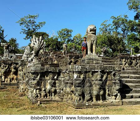 "Boy on the Terrace of the Elephants, wall-reliefs with garudas and lions at the Royal Palace, Angkor Thom, Siem Reap Province, Cambodia, Asia" View Large Photo Image Stock Image - "Boy on the Terrace of the Elephants, wall-reliefs with garudas and lions at the Royal Palace, Angkor Thom, Siem Reap Province, Cambodia, Asia". Fotosearch