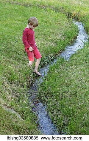 "Boy playing on a creek, Germany, Europe" View Large Photo Image Stock Photography - "Boy playing on a creek, Germany, Europe". Fotosearch
