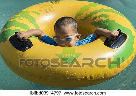 "Boy playing with a floating tire, Wonderla Amusement Park, Bangalore, Karnataka, India, Asia" View Large Photo Image Stock Photo - "Boy playing with a floating tire, Wonderla Amusement Park, Bangalore, Karnataka, India, Asia". Fotosearch