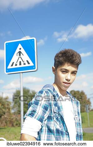 "Boy, portrait in front of a road sign" View Large Photo Image Stock Photograph - "Boy, portrait in front of a road sign". Fotosearch