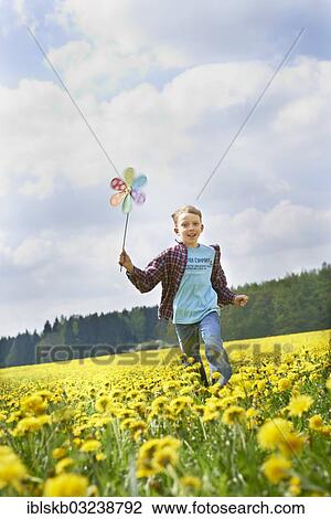 "Boy running with colorful pinwheel on dandelion meadow, Starnberg, Upper Bavaria, Bavaria, Germany, Europe" View Large Photo Image Stock Image - "Boy running with colorful pinwheel on dandelion meadow, Starnberg, Upper Bavaria, Bavaria, Germany, Europe". Fotosearch
