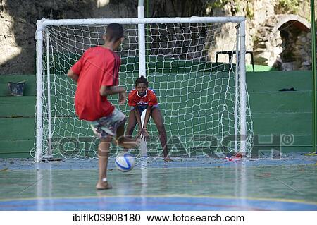 "Boy shooting a penalty kick towards a girl in the goal, Sao Martinho social project for street children, Lapa district, Rio de Janeiro, Rio de Janeiro State, Brazil, South America" View Large Photo Image Stock Image - "Boy shooting a penalty kick towards a girl in the goal, Sao Martinho social project for street children, Lapa district, Rio de Janeiro, Rio de Janeiro State, Brazil, South America". Fotosearch