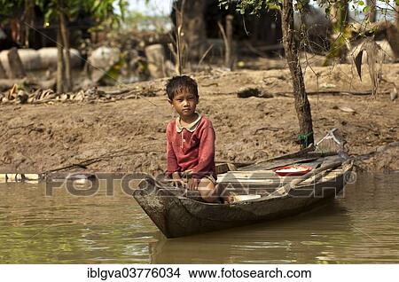"Boy sitting in a traditional boat on the Sangker river in Battambang, Battambang Province, Cambodia, Asia" View Large Photo Image Picture - "Boy sitting in a traditional boat on the Sangker river in Battambang, Battambang Province, Cambodia, Asia". Fotosearch