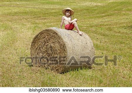 "Boy sitting on a bale of straw, Germany, Europe" View Large Photo Image Stock Image - "Boy sitting on a bale of straw, Germany, Europe". Fotosearch